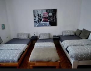 three beds in a room with a picture on the wall at E&B Pension in Ganderkesee