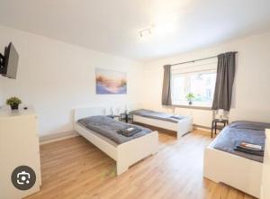 a living room with two beds and a couch at E&B Pension in Ganderkesee