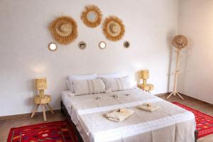 a bedroom with a bed with two towels on it at Villa Dar Nata in Tougouana +51 photos