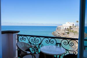 a balcony with a table and a view of the ocean at Hotel Nettuno in Forio d'Ischia