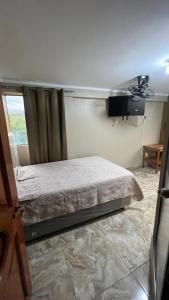 a bedroom with a bed in a room with a window at Hospedaje SAUNA & SPA NOAH in Bagua Grande