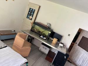 a hotel room with a fish tank on a desk at Saint varent guest place in Saint-Varent