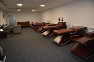 a waiting room with a row of brown chairs at Hotel HAVLOV in Žďárec +64 photos