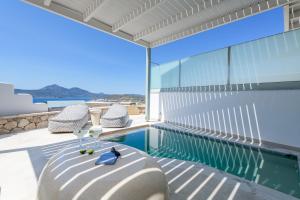 a swimming pool with a view of the ocean from a house at Hilltop Suites Milos in Mytakas