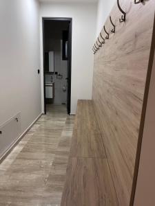 a hallway with a wall with a wooden counter at Hostel N&N in Kula +14 photos