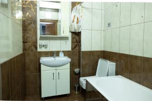 a bathroom with a white sink and a toilet at Apartaments Miro in Chişinău
