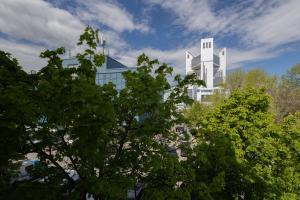 a white building with trees in front of it at Apartaments Miro in Chişinău