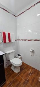 a bathroom with a toilet and towels on the wall at El Tesoro de Arturo in Tilapa +11 photos