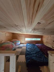 a small room with a bed in a wooden cabin at Meadowview Springs in Louisville