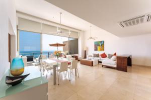 a dining room and living room with a view of the ocean at 1083 - Cosmo 3A3 in Tangolunda