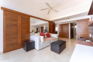 a living room with a white couch and a ceiling fan at 1083 - Cosmo 3A3 in Tangolunda