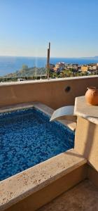 a swimming pool on the balcony of a building at Lussuoso B&B in Palmi