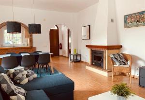 a living room with a blue couch and a fireplace at Casa Verdejo in Cómpeta
