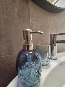 a bathroom sink with a bottle of soap on it at PapalePapale B&B in Viterbo