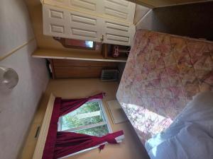 an overhead view of a bedroom and a window in a train at Twin Ayre Cabin Retreat Welshpool in Welshpool