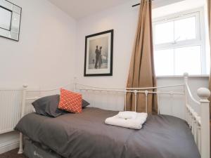 a bedroom with a bed and a window at Farriers Cottage in Bridlington
