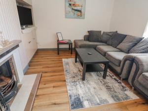 a living room with a couch and a coffee table at The Island's View in Letterkenny +23 photos