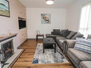 a living room with a couch and a fireplace at The Island's View in Letterkenny