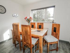 a dining room with a wooden table and chairs at The Island's View in Letterkenny