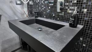 a bathroom sink with a soap dispenser on top of it at Manu's Guest Suite in Cosenza +65 photos