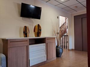 a living room with a tv on the wall at Hotel venta de Tébar in Águilas