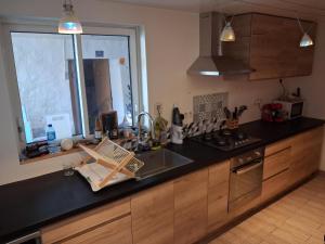 a kitchen with a sink and a counter top at Chambre dans maison paisible in La Ville-du-Bois