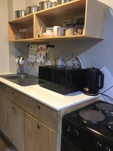 a kitchen with a microwave and a stove at Home at heart in Johannesburg