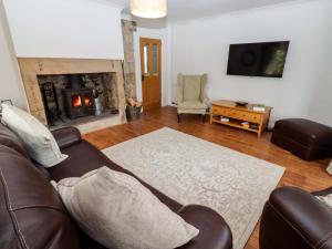 a living room with a couch and a fireplace at The Lodge in Alnwick