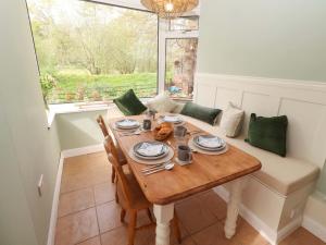 a dining room with a table and a window at The Lodge in Alnwick