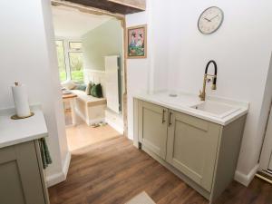 a kitchen with a sink and a clock on the wall at The Lodge in Alnwick +28 photos