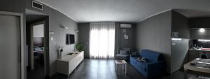 a living room with a blue couch and a blue chair at CRI'S & YOU guest room in Cosenza