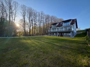 a large house on a large grass field at MazuryLive in Węgorzewo