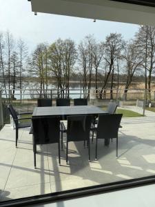a table and chairs sitting on a patio at MazuryLive in Węgorzewo