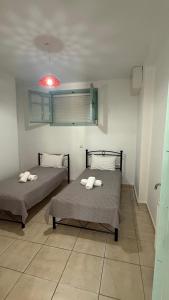a room with two beds and a red light at Apartment for Relaxed Holidays 3 in Kriezá