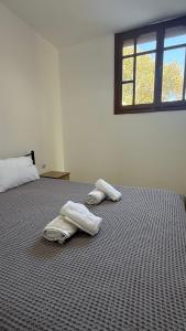 two towels on a bed in a room with a window at Apartment for Relaxed Holidays 3 in Kriezá