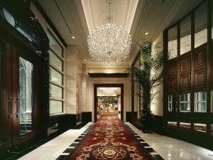 a hallway with a chandelier and a red carpet at Hotel La Suite Kobe Harborland in Kobe