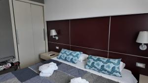 a hotel room with a bed with blue and white pillows at CRI'S & YOU guest room in Cosenza