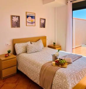 a bedroom with a bed with a tray of fruit on it at Espacioso Dúplex con terraza y vistas in Aguadulce +74 photos