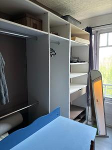 a room with an open closet with a desk at Saint varent guest place in Saint-Varent