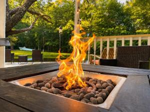 a fire pit on a patio with fire logs at Carriage House in Lufkin
