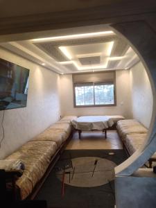 a living room with a couch and a table at Rabat Luxury in Salé