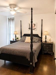 a bedroom with a black bed and two night stands at Carriage House in Lufkin