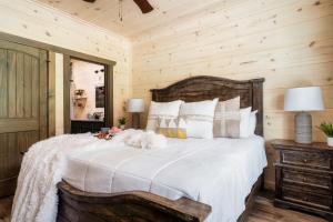 a bedroom with a large bed with a wooden wall at Paradise Point in Pigeon Forge