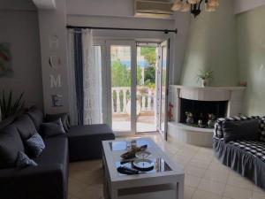 a living room with a couch and a fireplace at Villa Dani in Aigio +7 photos