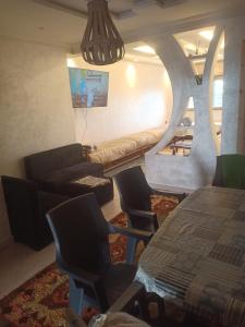 a living room with a couch and a table and chairs at Rabat Luxury in Salé