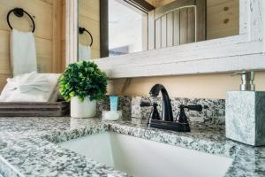a kitchen counter with a sink and a mirror at Paradise Point in Pigeon Forge +51 photos