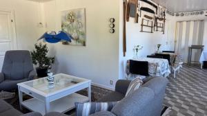 a living room with couches and a table at Hine Bakke Bed And Breakfast in Rudkøbing
