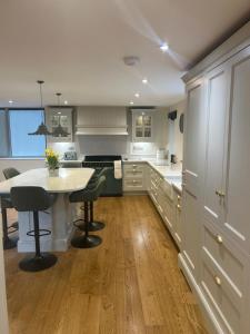 a kitchen with a table and some chairs in it at Ladywell Barn in Threshfield +51 photos