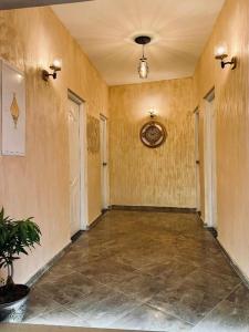 an empty room with a hallway with yellow walls at Ali City Hotel tunis in Tunis