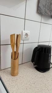 a container of wooden utensils sitting on a kitchen counter at Apartment for Relaxed Holidays 4 in Kriezá